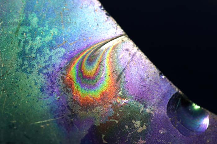 fles regenboog irisering Texel aanspoelsel