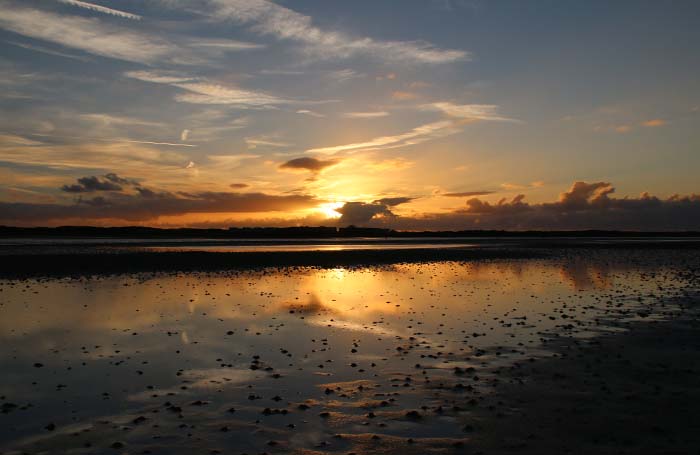 zonsondergang Mokbaai laag water eb