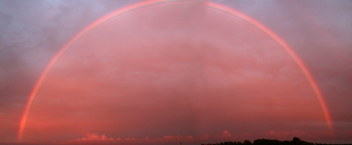 Regenboog zonsondergang